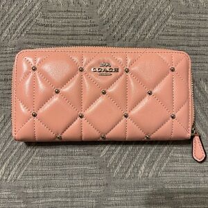 Coach pink accordion zip wallet with quilting and silver accents.